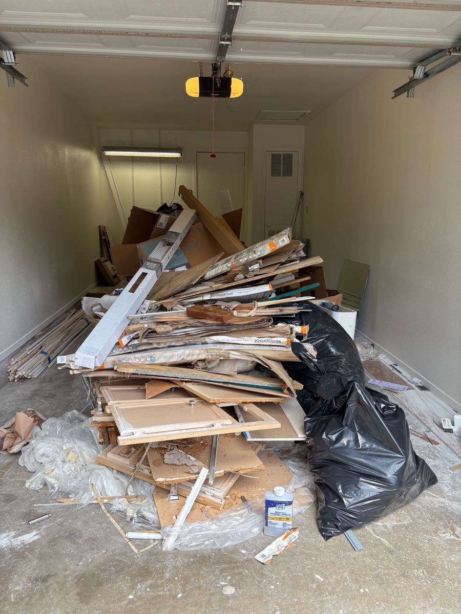 Garage in Southwest Austin packed with cabinet doors, flooring and lumber left over from a home renovation